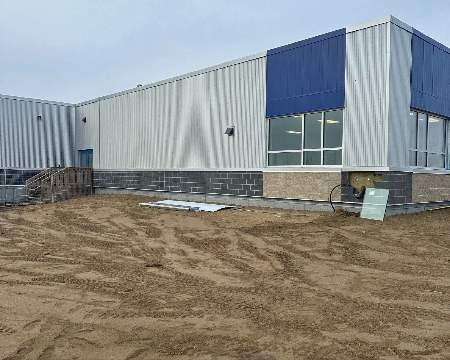 Metal cladding and masonry going up on a building under construction